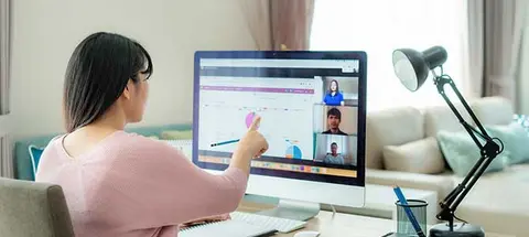 Asian business woman talking to her colleagues about plan in video conference. Multiethnic business team using computer for a online meeting in video call. Group of people smart working from home.